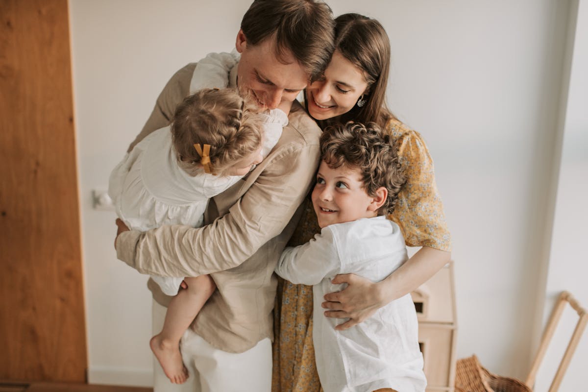Happy family hugging at home